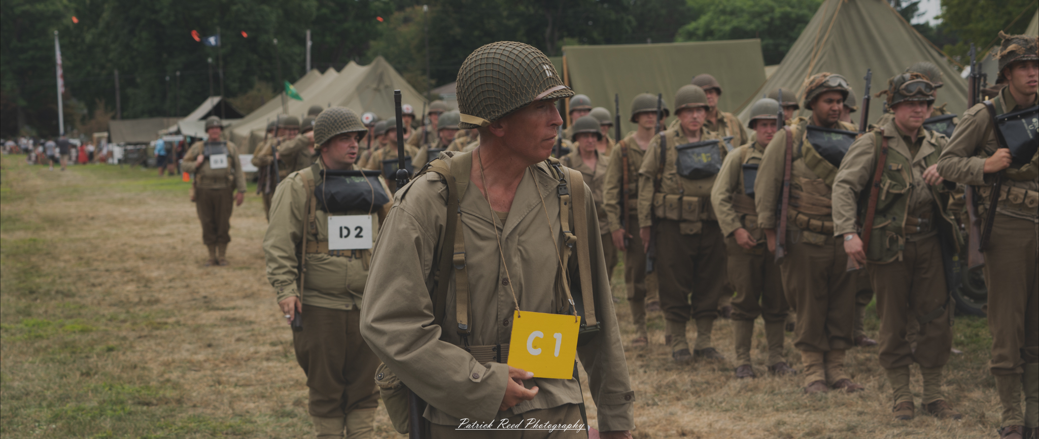 Soldiers preparing to embark, gathered with their gear and equipment. The scene captures the focus and anticipation as they get ready to move out, reflecting the readiness and determination of troops heading into the unknown.